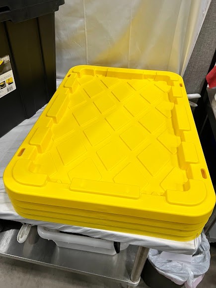 Sterilite 27 Gallon Black Industrial Storage Tote with Yellow Lily Lid – 4/Case